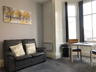 a living room with a couch and a table at Fishergate ApartHotel 2 - City Centre Location in Preston