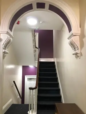 a staircase with an archway in a building at Fishergate ApartHotel 2 - City Centre Location in Preston
