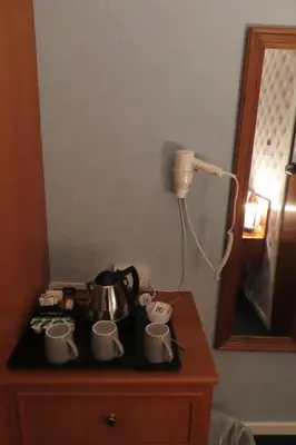 a table with a tea pot and cups on it at The Rowan Hotel in Blackpool