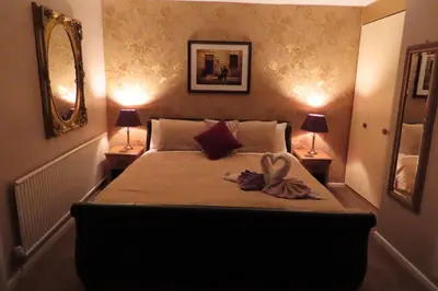 a bedroom with a bed with a towel on it at The Rowan Hotel in Blackpool