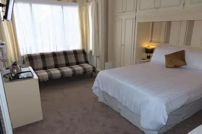 a hotel room with a bed and a couch at The Rowan Hotel in Blackpool