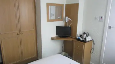 a hotel room with a bed and a television at The Rowan Hotel in Blackpool