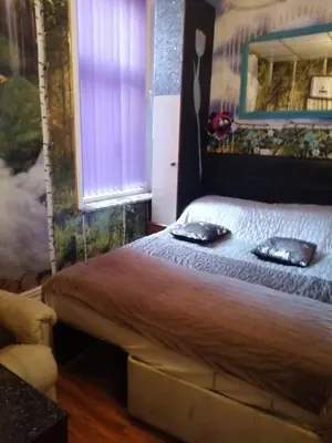 a bedroom with a bed with two pillows on it at K.k's North Station Self catering holiday apartments in Blackpool