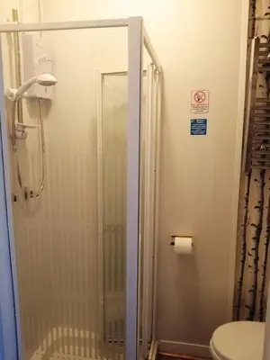 a shower with a glass door in a bathroom at K.k's North Station Self catering holiday apartments in Blackpool
