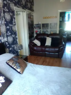 a living room with a couch and a leather couch at K.k's North Station Self catering holiday apartments in Blackpool