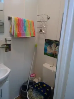 a bathroom with a toilet and a colorful towel at K.k's North Station Self catering holiday apartments in Blackpool