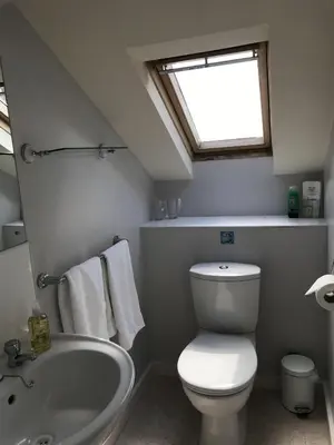 a bathroom with a toilet and a sink and a window at The Bowden Lodge Complimentary afternoon tea 15th Mar '26 Terms and Conditions apply in Southport