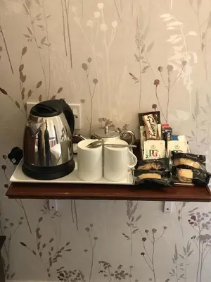 a shelf with a coffee pot and cups on it at The Bowden Lodge Complimentary afternoon tea 15th Mar '26 Terms and Conditions apply in Southport