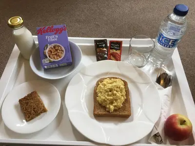 a white tray with a plate of food on a table at The Bowden Lodge Complimentary afternoon tea 15th Mar '26 Terms and Conditions apply in Southport