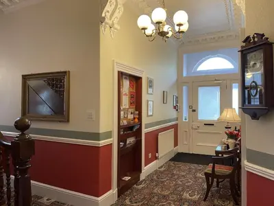 a hallway with a door and a table and chairs at The Bowden Lodge Complimentary afternoon tea 15th Mar '26 Terms and Conditions apply in Southport