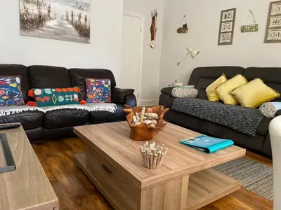 a living room with a couch and a coffee table at Beach Hideaway in Lytham St Annes