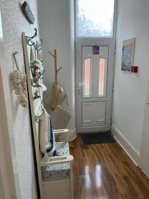 a hallway with a white door and a wooden floor at Beach Hideaway in Lytham St Annes