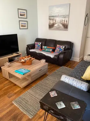 a living room with a couch and a coffee table at Beach Hideaway in Lytham St Annes
