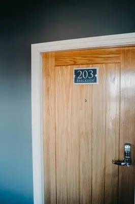 a sign on a door with a sign on it at Flat Iron Anfield in Liverpool