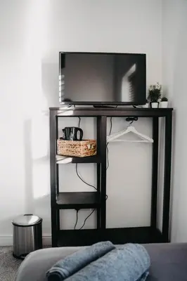 a black tv stand with a television on it at Flat Iron Anfield in Liverpool