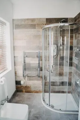 a bathroom with a shower and a toilet at Flat Iron Anfield in Liverpool