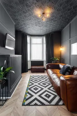a living room with a leather couch and a rug at Stanley House - Air Host & Stay - 4 Bedroom in Liverpool