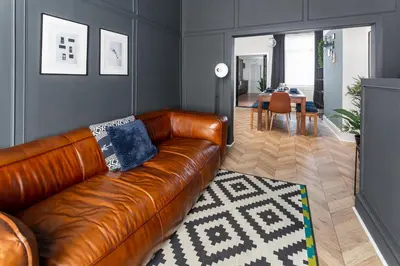 a living room with a brown leather couch and a dining room at Stanley House - Air Host & Stay - 4 Bedroom in Liverpool