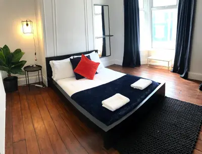 a bedroom with a bed with two pillows on it at Stanley House - Air Host & Stay - 4 Bedroom in Liverpool