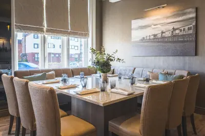 a dining room with a long table and chairs at The Grand Hotel in Lytham St Annes