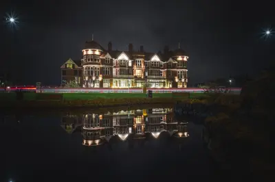 a large house is lit up at night at The Grand Hotel in Lytham St Annes