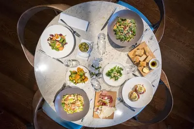 a round table with plates of food on it at The Grand Hotel in Lytham St Annes