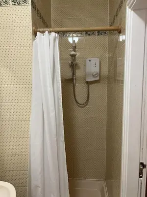 a shower with a white shower curtain in a bathroom at Royal Oak Hotel, Garstang in Garstang