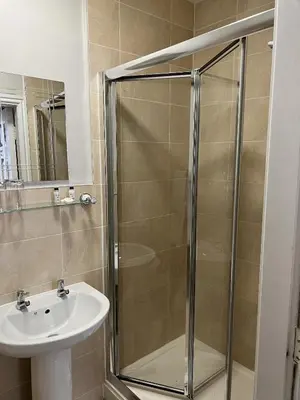 a bathroom with a shower and a sink at Royal Oak Hotel, Garstang in Garstang