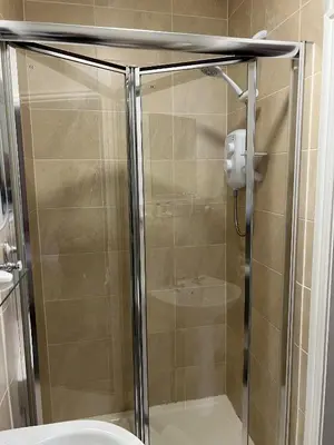 a glass shower stall with a toilet in a bathroom at Royal Oak Hotel, Garstang in Garstang