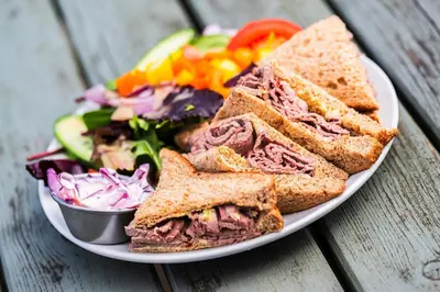 a plate with a sandwich and a salad and a salad at Royal Oak Hotel, Garstang in Garstang