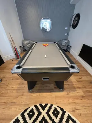 a pool table with a ball on top of it in a room at Bluebell Hotel in Blackpool