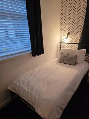 a bed with a pillow on it in a bedroom at Bluebell Hotel in Blackpool