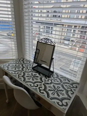 a painting on a table in a room with a window at Bluebell Hotel in Blackpool