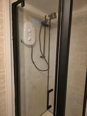 a shower with a shower head in a bathroom at Bluebell Hotel in Blackpool