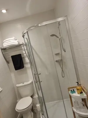 a bathroom with a shower and a toilet at The Racquet Club in Liverpool