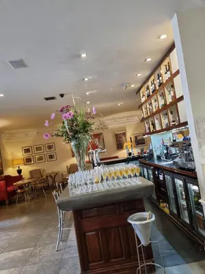 a bar with glasses and a vase of flowers at The Racquet Club in Liverpool