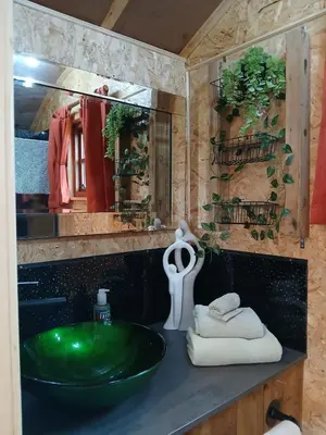 a bathroom with a green sink and a mirror at Little Oakhurst in Clitheroe