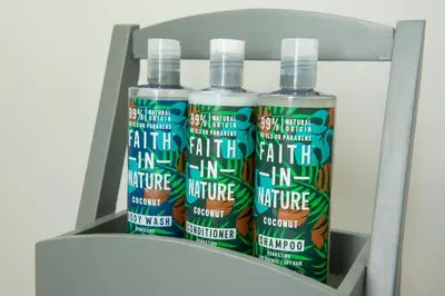 a shelf with three bottles of paint and a light at Little Oakhurst in Clitheroe