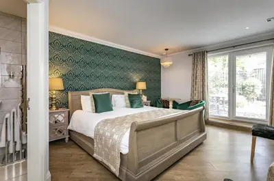 a bedroom with a bed and a green wall at Willow Lodge Hambleton in Poulton le Fylde