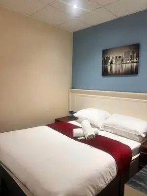 a hotel room with two beds and a painting on the wall at The oxford Hotel in Blackpool