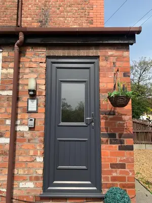 a black door on a brick house with a window at Be My Guest Liverpool - Ground Floor Apartment with Parking in Liverpool