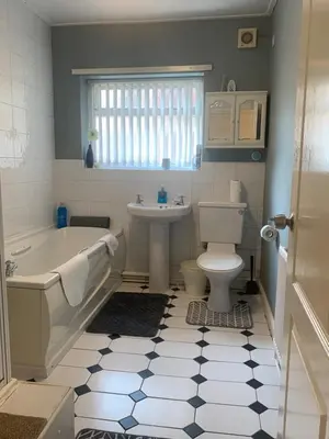 a bathroom with a tub and a toilet and a sink at Be My Guest Liverpool - Ground Floor Apartment with Parking in Liverpool
