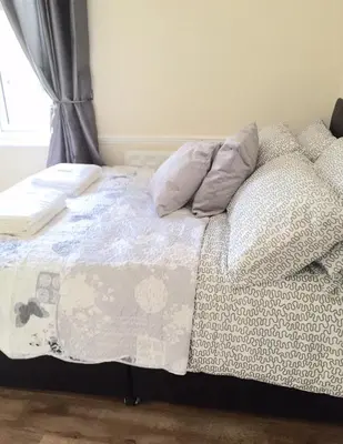 an unmade bed in a bedroom with a window at Be My Guest Liverpool in Liverpool