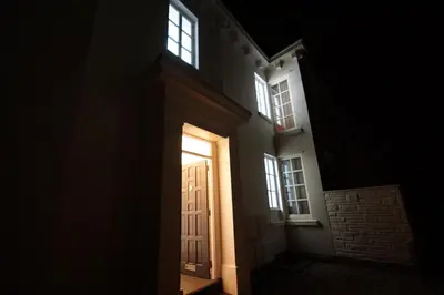 a light shines through a door at night at Grade 2 Listed Apartment, Southport Promenade in Southport