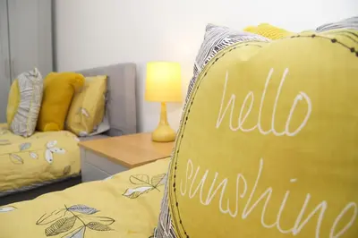 a bed with a pillow with the word kill autumn written on it at Grade 2 Listed Apartment, Southport Promenade in Southport