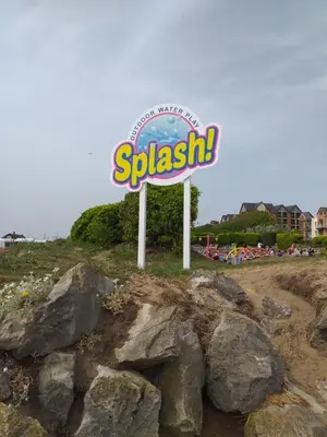 a sign for asplash sign on a hill with rocks at The Clevedon in Blackpool