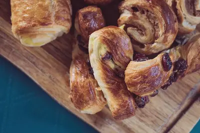 a wooden plate with various types of pastries on it at The New Inn in Carnforth
