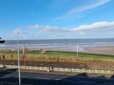 a view of a beach with the ocean in the background at Granada Apartments Queen's Promenade in Blackpool