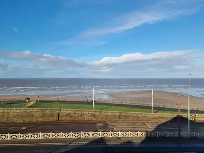a view of a beach with the ocean in the background at Granada Apartments Queen's Promenade in Blackpool