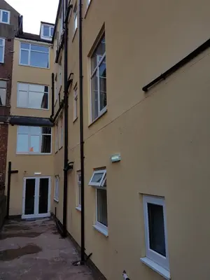 an alley between an apartment building with windows at Granada Apartments Queen's Promenade in Blackpool